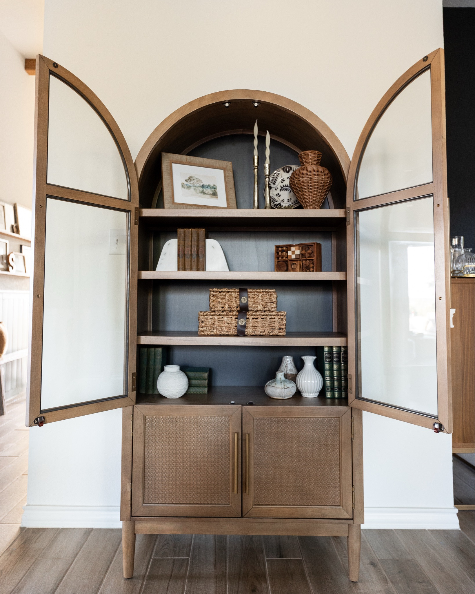 One of my favorite ways to style shelves is mixing new finds with pieces that actually mean something 🤎 I filled this arched cabinet with woven baskets, decorative vases, candlesticks, taper candles, and old books that have been passed down through our family.

The woven baskets are one of my favorite affordable finds — they have such a similar look to the McGee & Co. ones for a lot less!

#LTKHome #LTKSaleAlert