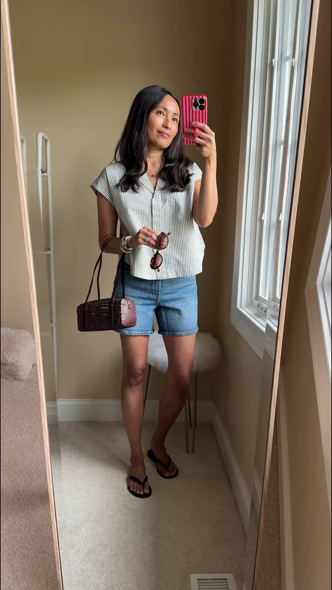 Elevated classic summer outfit. 
- Swapped my usual t-shirt for a relaxed cotton top. Easy breezy effortless chic kind of style. 
- Added warm toned summer accessories and classic flat leather sandals. 

- Exact items:  
Top: I love this cotton seersucker fabric. Would be a closet staple also in white. True to size. 
Denim shorts:  classic high waisted fit with a bit of stretch. Good length and flattering fit. Size up. 
Bag:  pretty woven rattan look to this leather mini bag. Everyday essentials size. 
Sunglasses: my favorite addition to my collection. The oval shape is a fun change up from my usual oversized rectangle style. 
Flat thong sandals: go with everything. I would love to have in dark brown too. Size up.

#LTKootd #LTKOver40