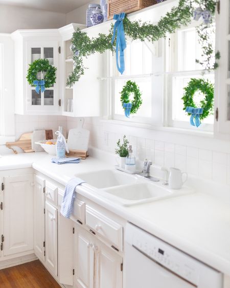 Simple blue Christmas decor 💙 It’s amazing how far a few boxwood garlands, 11-inch wreaths, and spools of velvet ribbon can go when it comes to holiday decor! Follow me on the LTK all for more kitchen decor ideas and affordable Christmas decorations! 

#LTKHoliday #LTKSeasonal #LTKhome