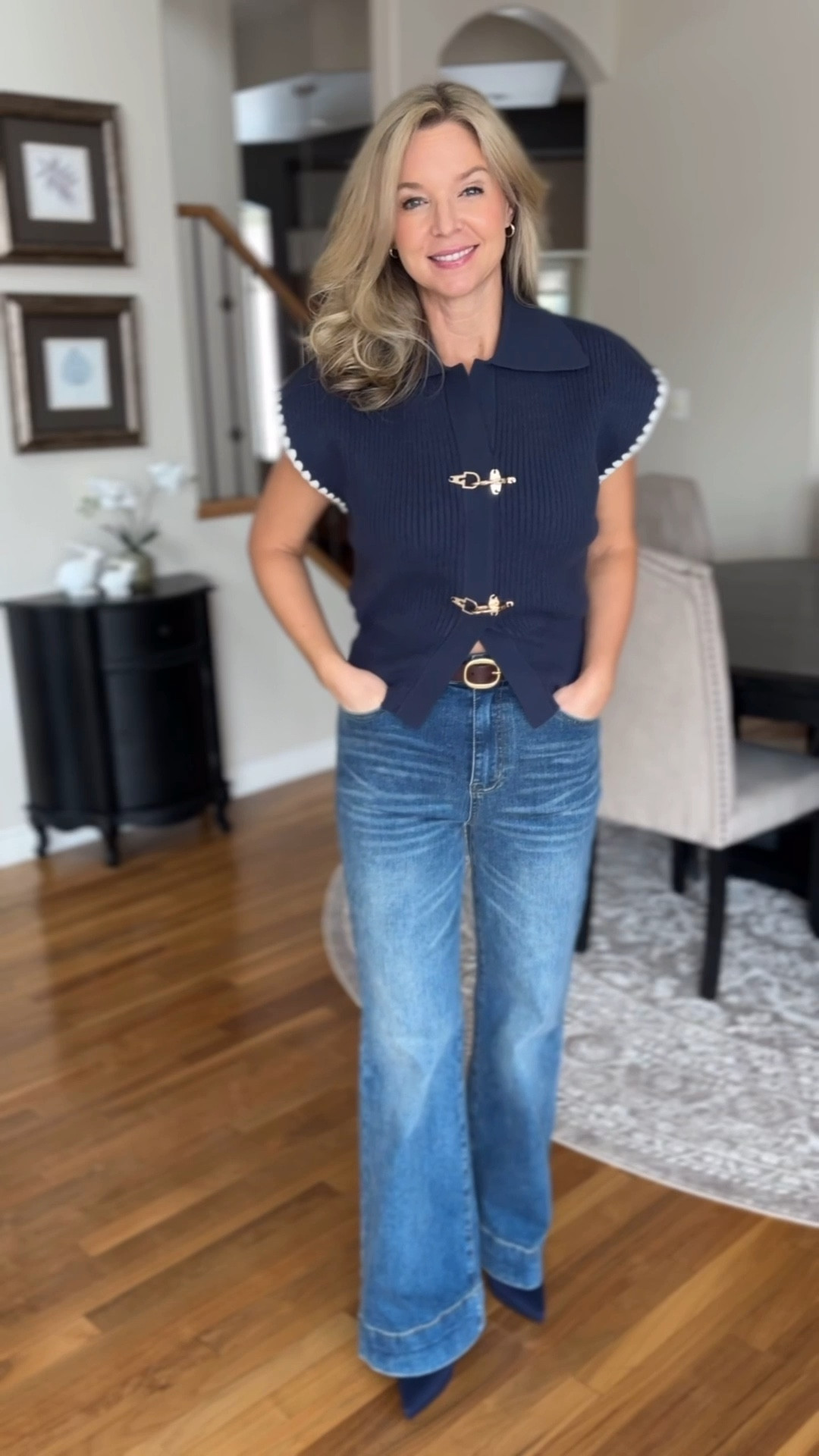 Here’s cute navy sweater with flutter sleeves and some gold hardware on the front. 

#LTKootd #LTKmomlife #LTKWorkwear