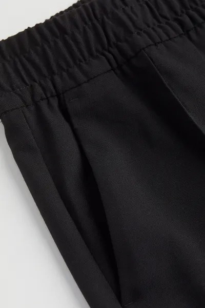 Tailored trousers in twill made from a viscose blend. High waist with covered elastication, side ... | H&M (UK, MY, IN, SG, PH, TW, HK)