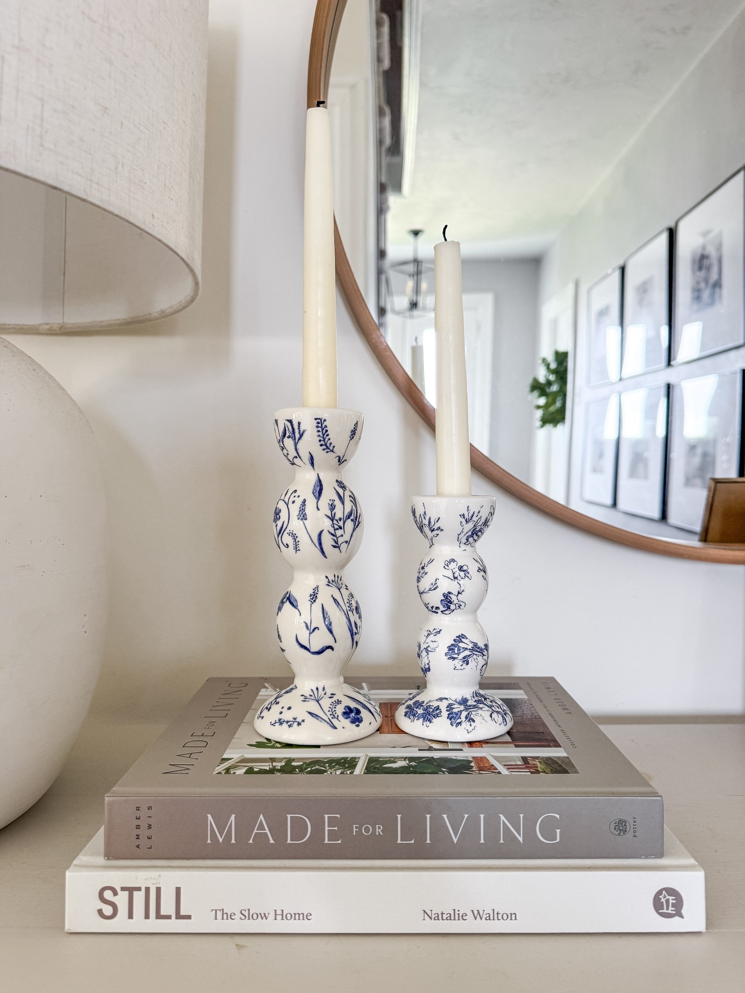 Spring console table decor. Blue and white vintage candleholders. Coffee table book stack. Ceramic candle holders. Spring decor. 

#LTKHome #LTKSeasonal