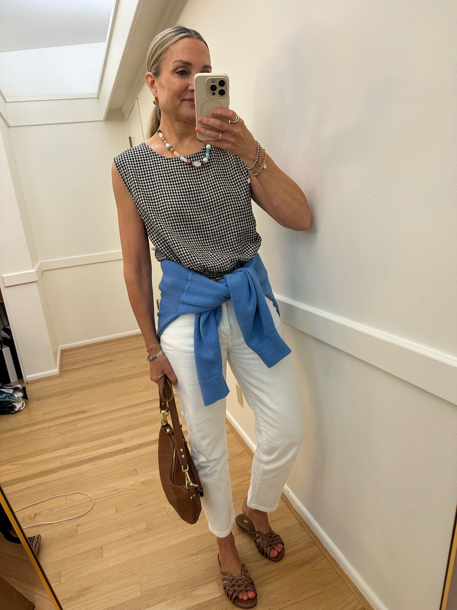 Outfit of the day: @zsupplyclothing gingham bubble top with @Zara white jeans, @Quince woven bag and brown sandals. Uniqlo knit sweatshirt.

#LTKootd #LTKOver40 #LTKgrwm