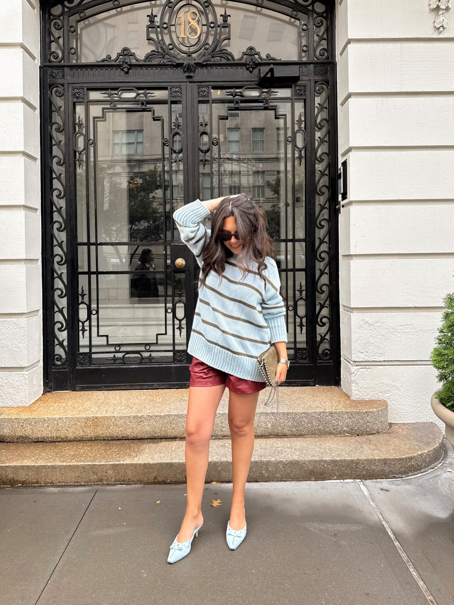 An easy fall transition outfit idea for September 🍂 Styling an oversized striped sweater with burgundy leather shorts and pastel heels for a mix of cozy and chic. Perfect for warm fall days in NYC or early fall weekends. Linking my exact accessories + similar striped knits, faux leather shorts, and pastel heels under $100 so you can shop the look