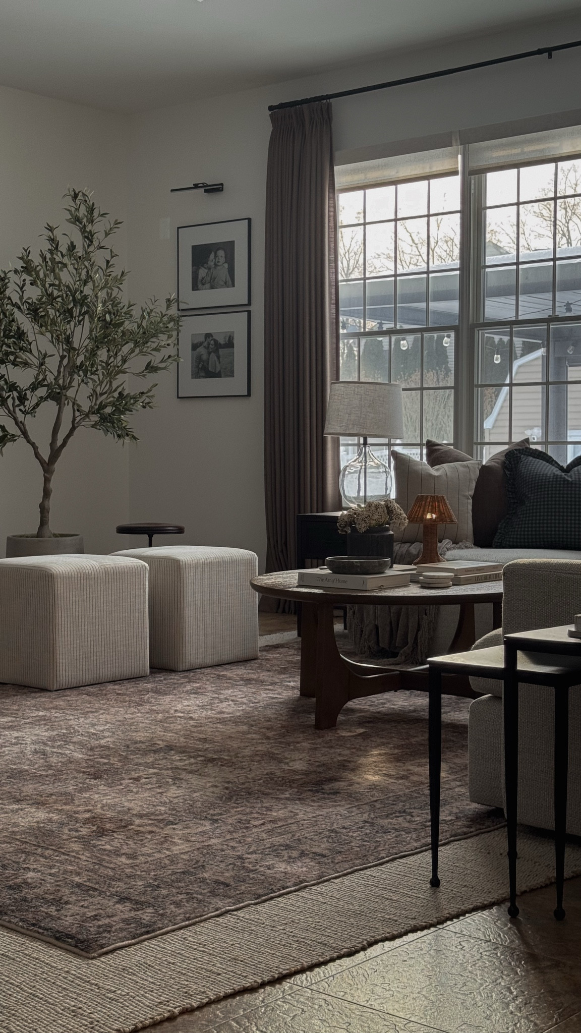 Living room decor, round coffee table decor, nesting side table, Ottomans, Amazon curtains, olive tree, spring decor, round coffee table styling, living room rug

#LTKHome