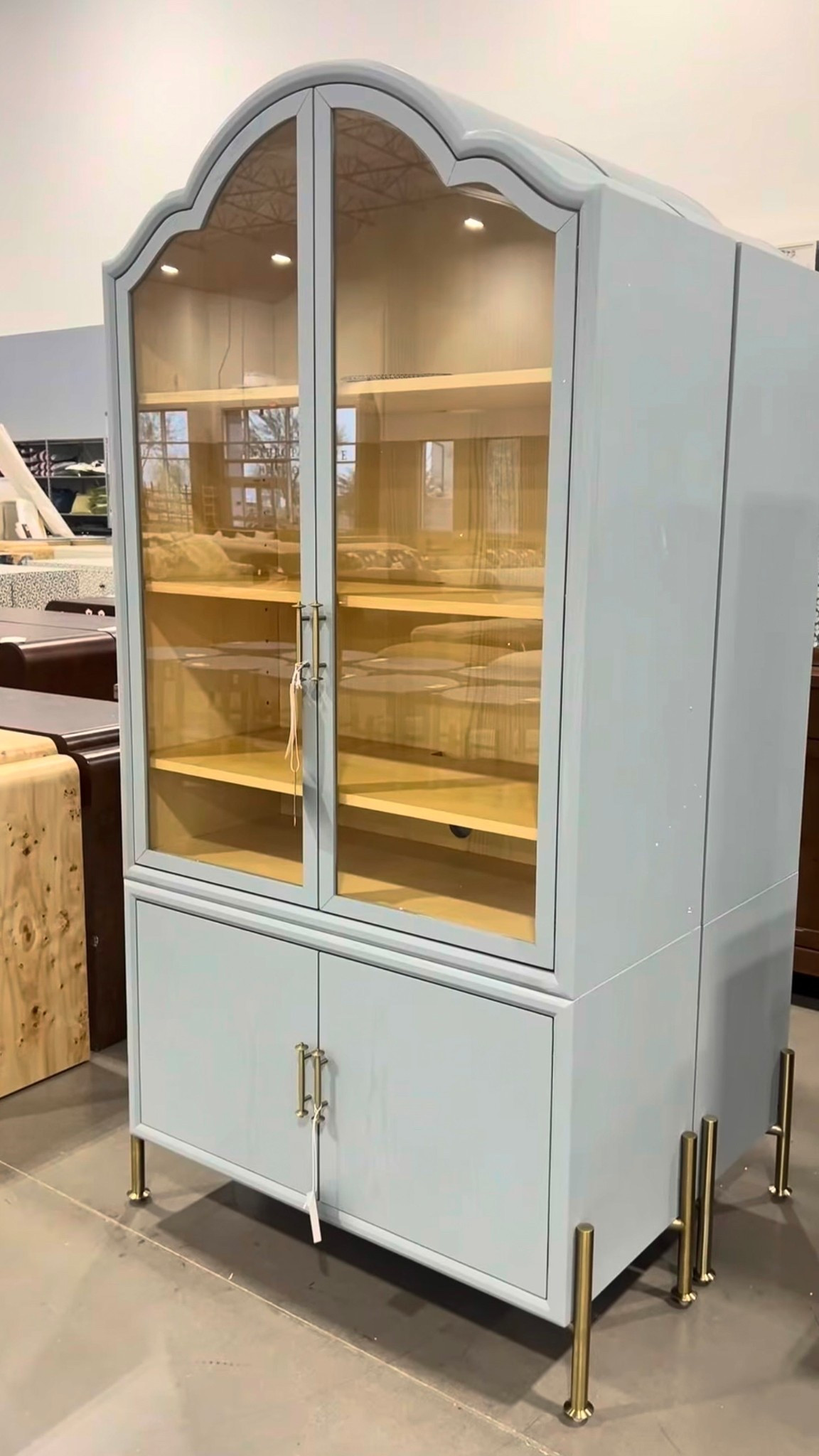 The Livia Glass & Wood Storage Hutch from Anthropologie is such a lovely statement piece. 🤩 The light blue-gray finish is especially beautiful—soft, elegant, and easy to style with so many interiors. The arched glass doors, slim legs, and gold knob accents give it that refined, designer feel. 💫 Perfect for displaying favorite pieces up top while keeping extra items stored below. It also comes in multiple colors, so you can choose the look that fits your space best. Linked it here along with other beautiful cabinet finds! 🩵 #StatementCabinet #DisplayCabinet #Anthroplogie

#LTKSaleAlert #LTKHome