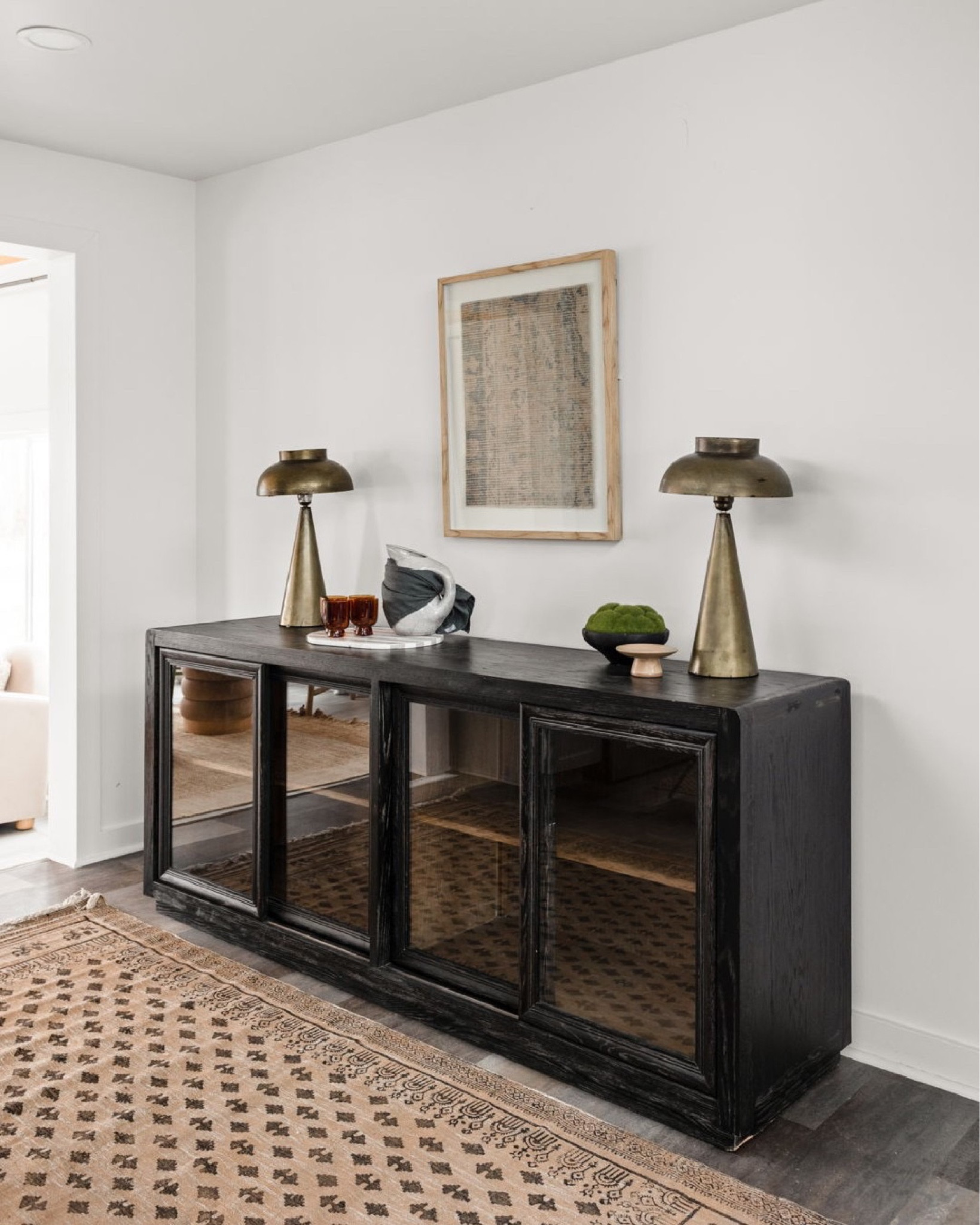 Fill an empty wall with a sideboard and decor for added stir and interest .

#LTKhome