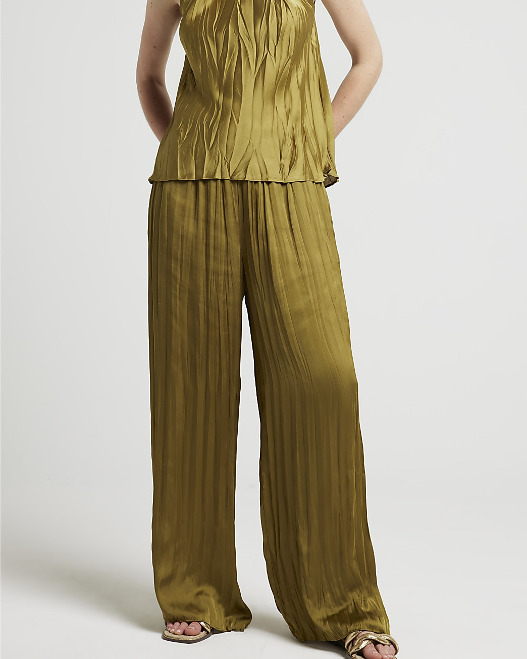 Khaki satin plisse wide leg trousers | River Island (UK & IE)