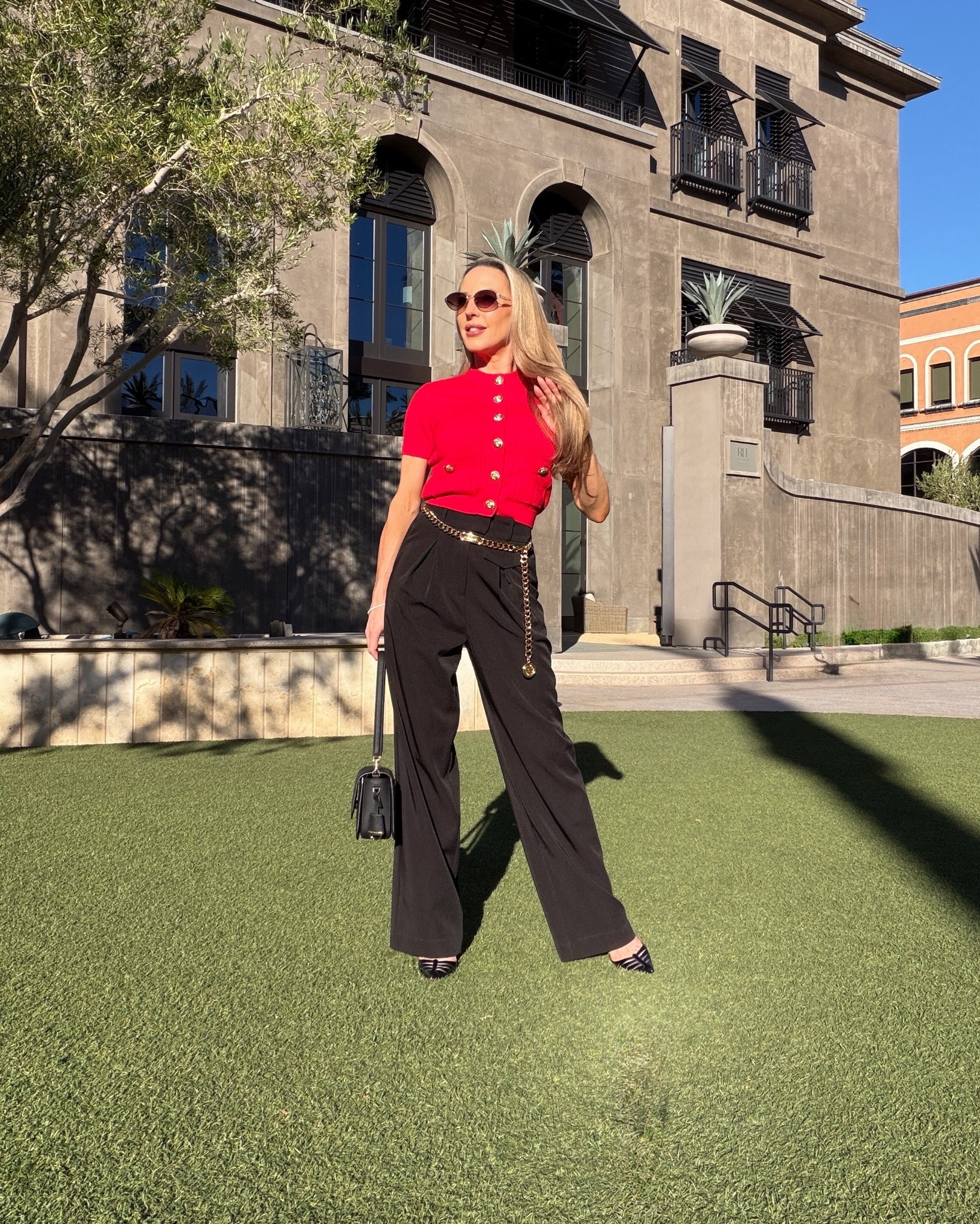 OOTD Fall outfit idea: black high waisted pants, gold chain Chanel belt, red cap sleeve cardigan with gold buttons, black Christian Louboutin heels, Quay oval sunglasses from their limited-edition holiday collection ( crafted with delicate metal work and embellished pearly details), and a black leather shoulder flap bag.

#LTKStyleTip #LTKShoeCrush #LTKSeasonal