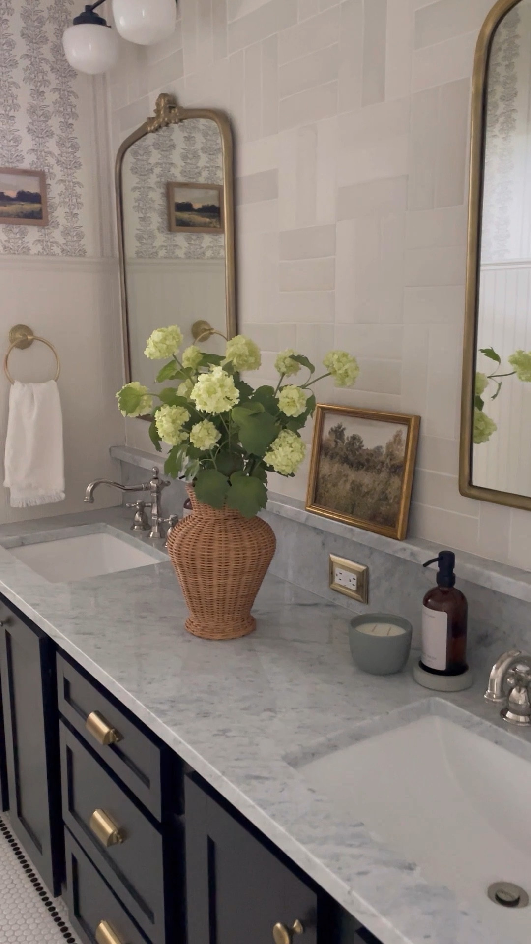 DIY bathroom reno: we repurposed the cabinets and kept the builder grade tub, but swapped out the linoleum floors for penny tile, added tile behind the new vanity mirrors, added beadboard and wallpaper, and called it good. I love it now! 

#LTKstyletip #LTKhome #LTKSeasonal