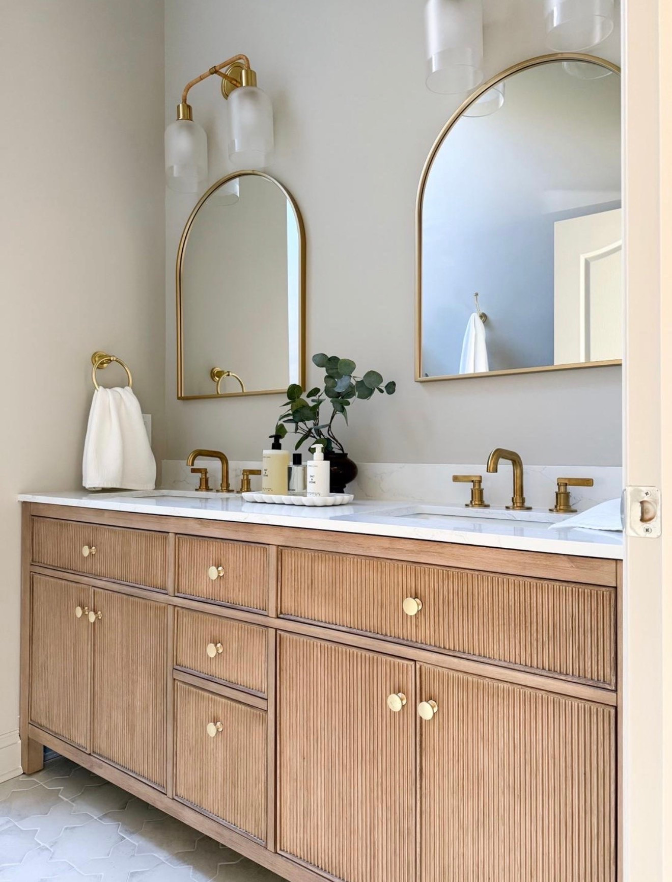 We gave this shared bathroom the prettiest facelift with a brand new double vanity, the prettiest sconces, arched mirrors and brass accents. The vanity comes with a marble countertop and brass hardware - such a stunning piece.

#LTKSaleAlert #LTKHome #LTKmorningroutine
