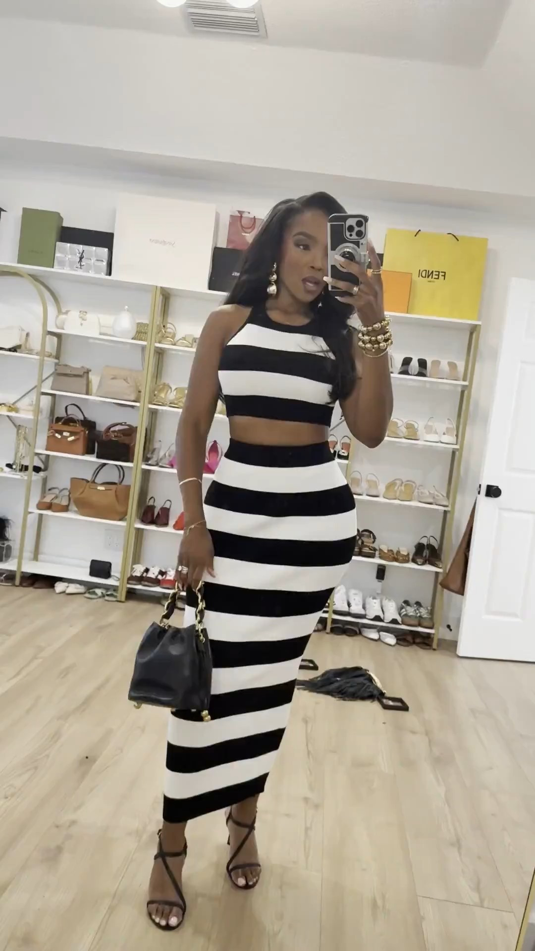 Bold stripes, sculpted silhouette 🖤🤍  

This black and white striped two-piece is giving modern, confident, and timeless all at once. The cropped top balances the high-waisted midi skirt perfectly, creating a flattering hourglass shape while keeping it polished. Pieces like this are easy to restyle — pair the skirt with a bodysuit, the top with denim — and suddenly the cost per wear makes total sense.

Classic print. Strong presence.

Perfect for:
• Date nights  
• Dinner parties  
• Vacation evenings  
• Chic city outings  

📏 Sizing:  
Top: Size Small  
Skirt: Size Small  
Heels: True to size  

📐 Measurements:  
5’4” · 138 lbs · 34D bust · 27” waist · 40” hips  

Save this if you love a bold stripe moment.

Black and white striped set, striped midi skirt outfit, chic two piece set women, fitted vacation outfit, modern feminine silhouette, statement stripe look.

Follow me on Instagram and YouTube @k