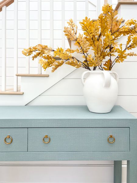 Loving our new blue linen console table paired with this oversized white vase and golden faux oak leaves (I used three stems but they are each very large). The entryway table is currently on sale too!

#ltkhome #ltksalealert #ltkseasonal #ltkunder100 #ltkfind #ltkstyletip entryway decor, foyer table, coastal style, simple fall decor

#LTKhome #LTKSeasonal #LTKsalealert