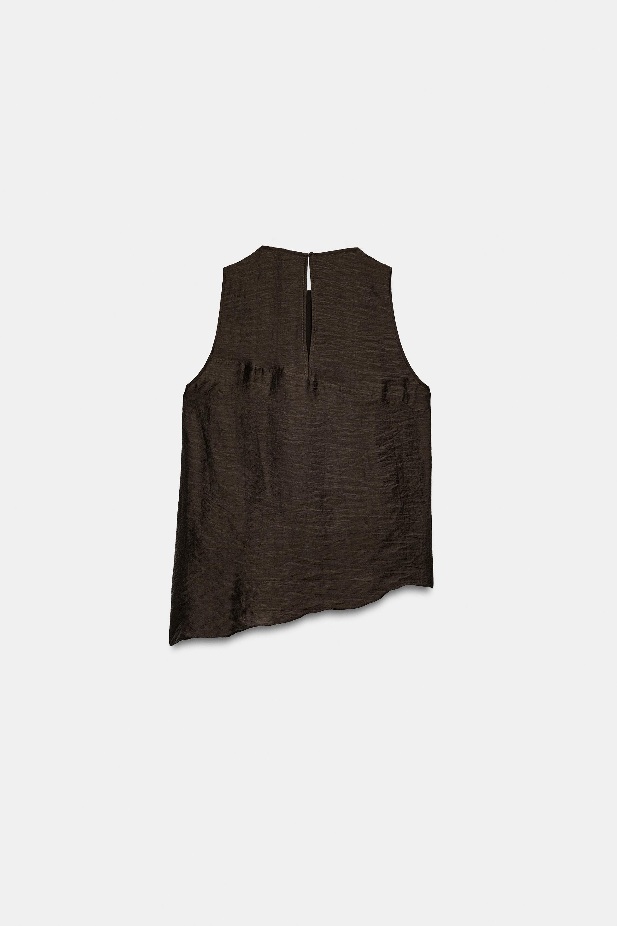 Model height: 177 cmRound neck and sleeveless top. Features ruffled details and an asymmetric hem... | Zara DE