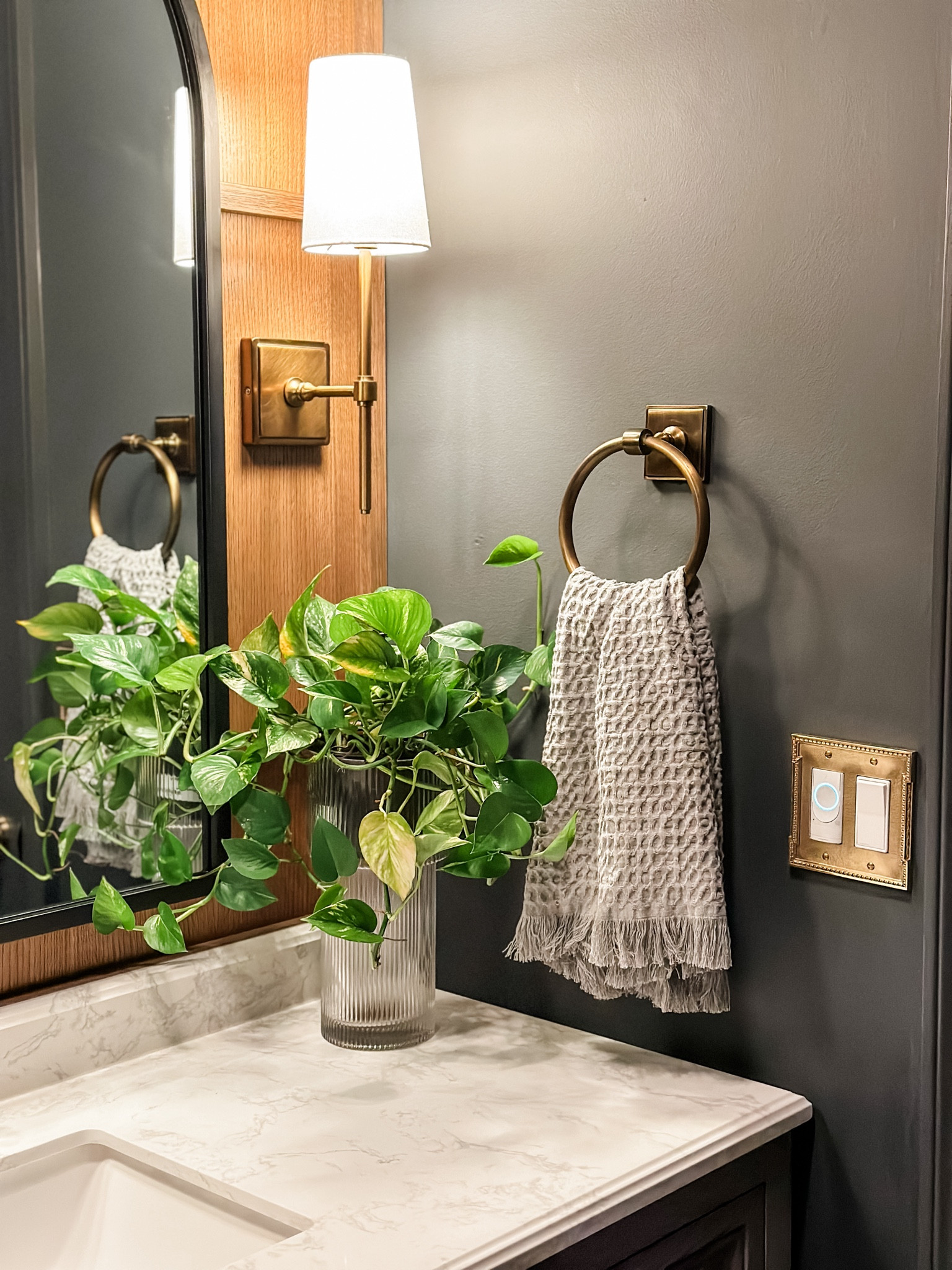 Bathroom decor • bathroom fixtures • ribbed vase • fluted vase • vintage brass towel ring • brass sconces • traditional home decor • bathroom makeover • bathroom renovation • 

#LTKhome