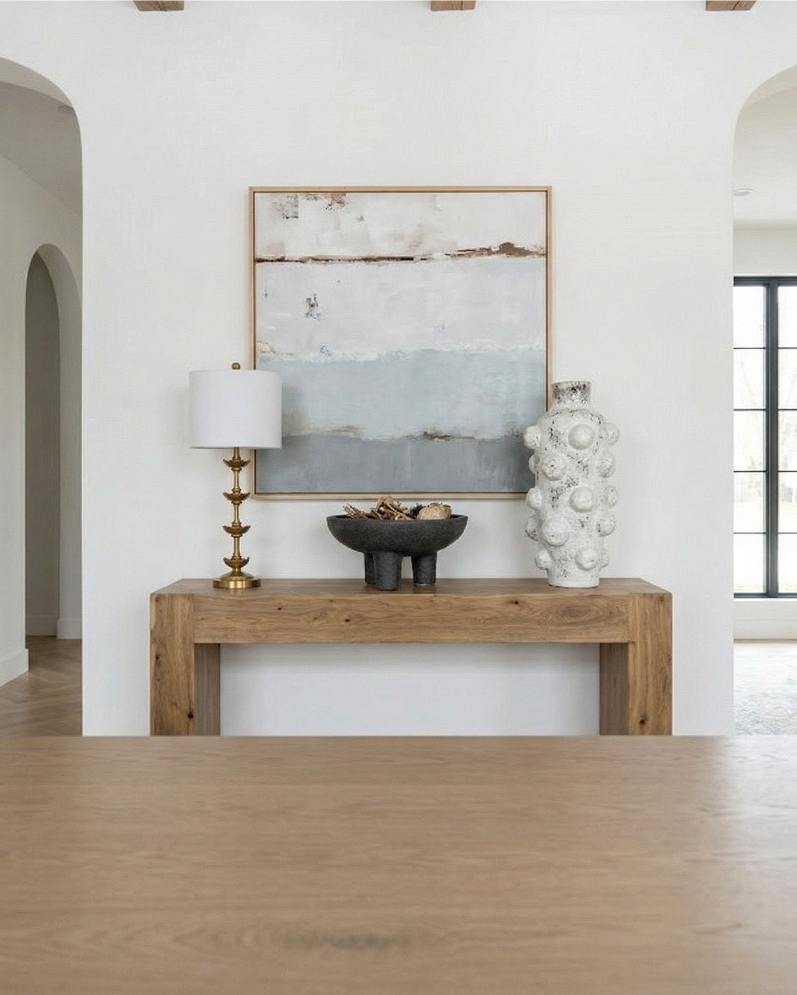Shop the look: 
* Wood Dining Table
* Black upholstered dining  Chairs 
* Wood console table
* Brass table lamp 
* White ceramic vase
* Brass candle holders
* Blue wall art
* Neutral modern wall art
* Brass wall sconce 
* Wood cabinets 
* Blue traditional pattern rug
* Blue wall paper
* Tall ceramic vase
* Black decor bowl

#LTKhome #LTKsale #LTKstyletip