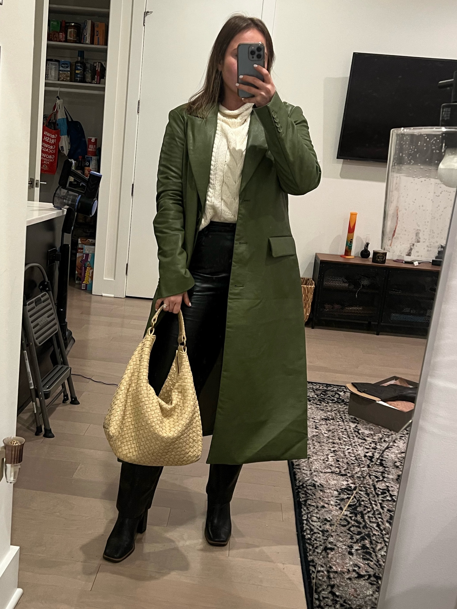Green leather long blazer jacket with chunky cream knit sweater and Aritzia black leather pants. The perfect mid calf black bootie from Franco sarto  Bottega bag from the real real 