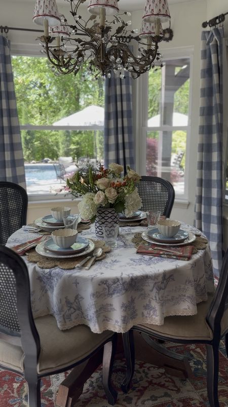 Pleated chandelier shades, breakfast nook ideas and decor, crystal chandelier, faux beams, French scene toile tablecloth, rug, colorful rugs, gingham curtains, buffalo check drapes, cane dining chairs

#LTKhome #LTKsalealert #LTKVideo