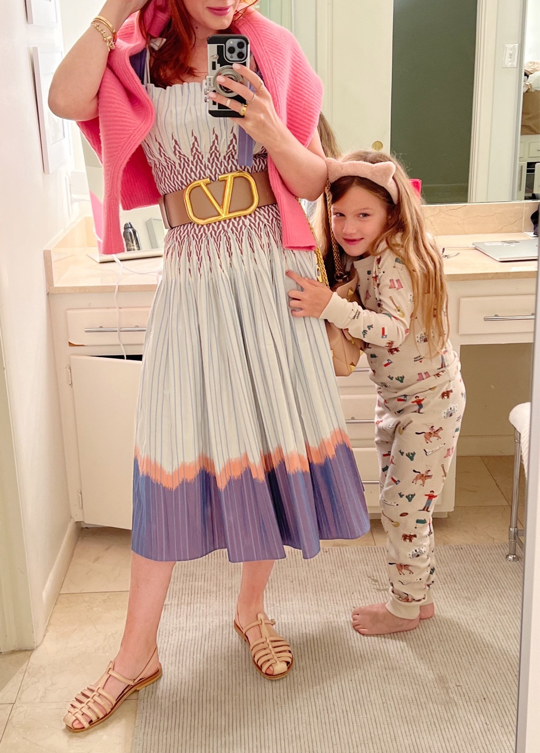 My dress is on sale and it’s super flattering. I like it with and without this belt- wore the belt to dress it up a bit for a girls dinner. 
I have found a lot of hot pink lately - Valentino is leaning into it big time - so I draped my pink cardigan around my shoulders to add some styling to this look 
I dress my Valentino accessories up with heels and down with flats- all in this nude color. 

#LTKSeasonal #LTKU #LTKwedding