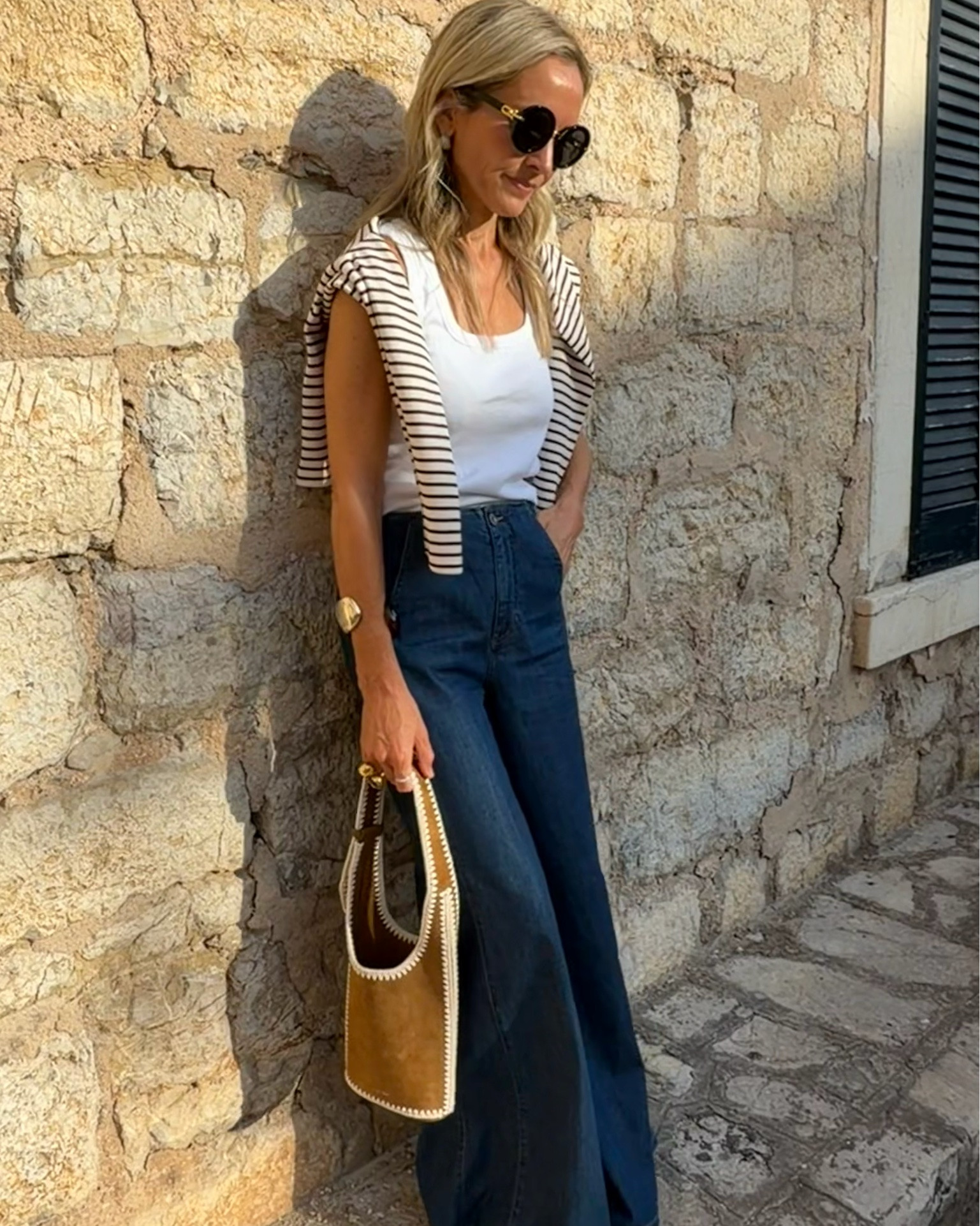 Some combinations just work. A Breton, great wide-leg denim and a beautiful suede bag… the kind of pieces you'll reach for on repeat.
I've been carrying the Veronica Beard Whipstitch Loop Bag recently and it's such a beautiful piece. The structured silhouette, rich suede and signature whipstitch detailing make it feel both classic and distinctive. One of those bags that makes even the simplest outfit feel that bit more considered. 🤎
Also the sandals are in the sale whoop 🙌

#LTKuk #LTKsummer #LTKsale