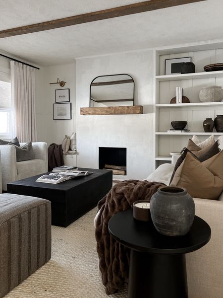 winter organic modern living room styling - cozy, warm browns + neutrals, loads of texture 

home decor. Living room. Jute rug. Ottoman. Brown pillows. Throw pillow. Fur throw blanket. Arch mirror. Boucle chair. Coffee table  

#LTKfindsunder50 #LTKSeasonal #LTKhome
