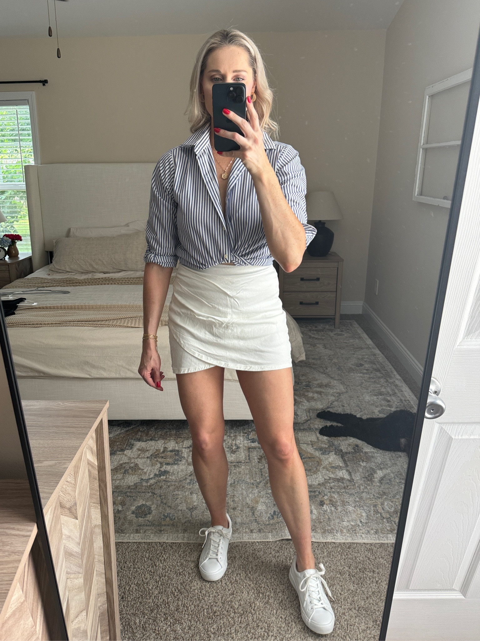 White and blue striped button down, white skirt and white sneakers 