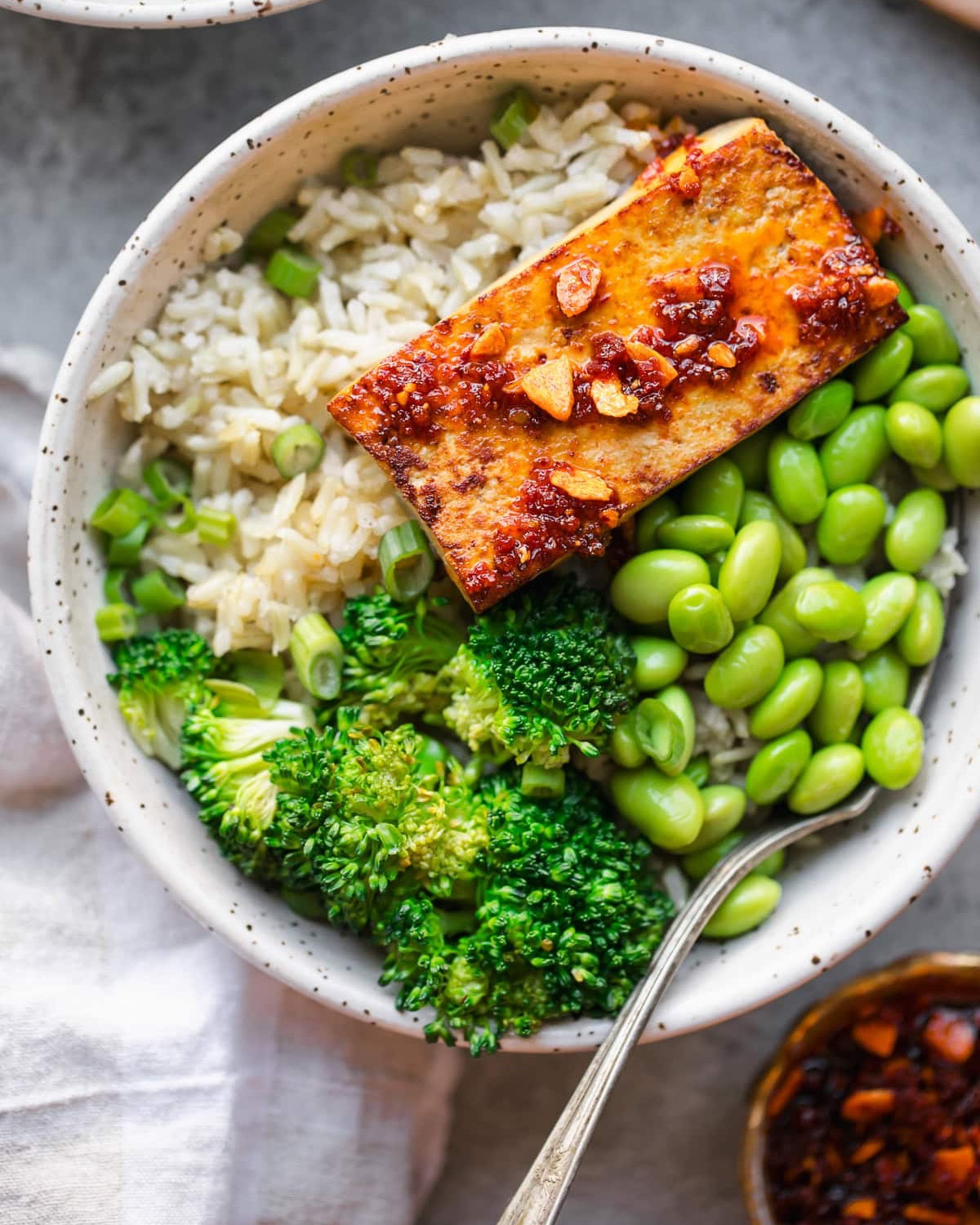 Crunchy Garlic with Chili Oil so good on these Tofu Bowls! 

Pan Seared Tofu Bowls Recipe on www.skinnytaste.com 
https://www.skinnytaste.com/pan-seared-tofu-bowls/

#recipe #tofu #chilioil