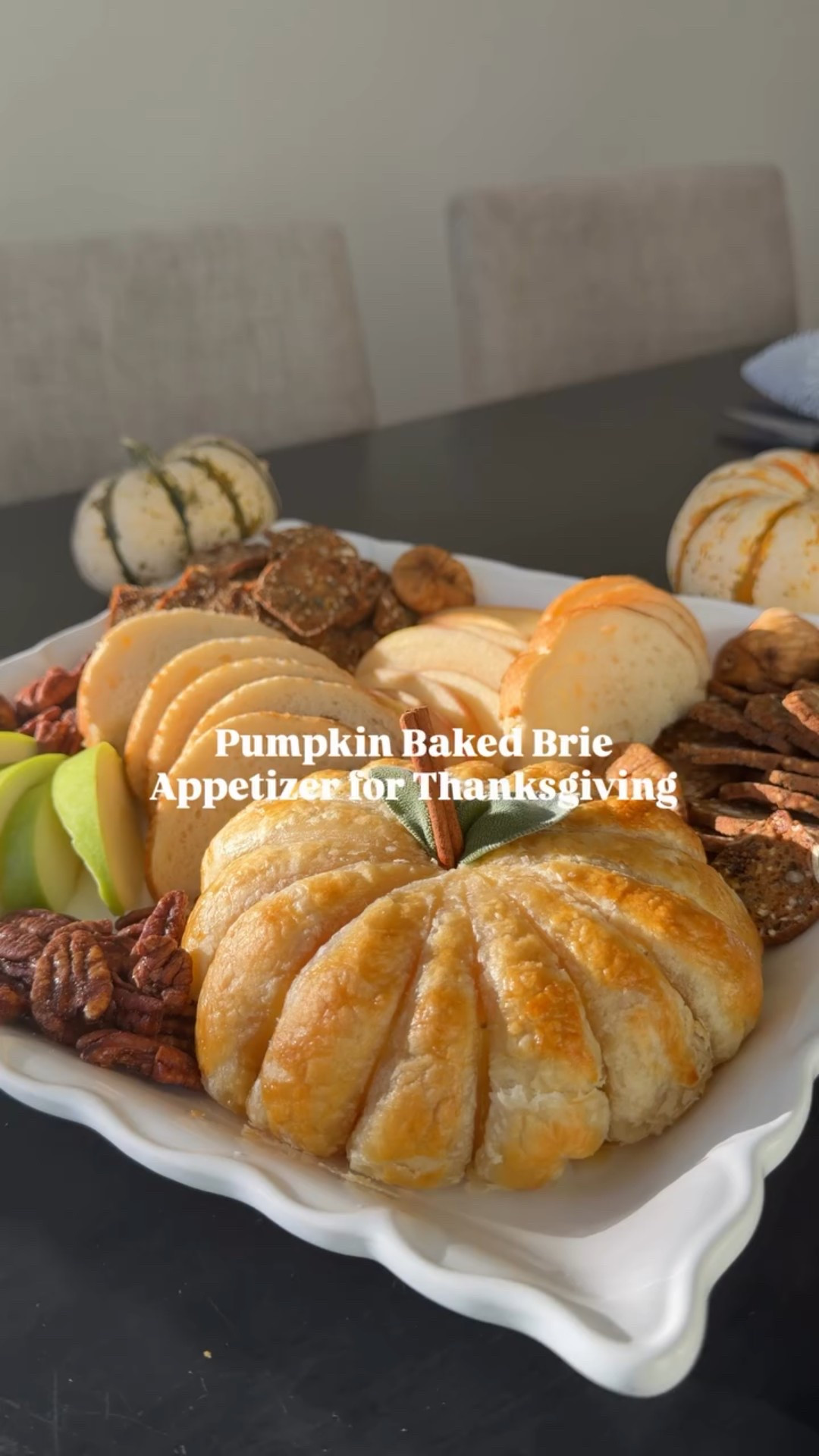 I made this pumpkin Brie baked appetizer for a test kitchen Friendsgiving. It looks way fancier than it actually is! Simple to make & leveled up the fall vibes for a thanksgiving charcuterie board. Screen shot the recipe at the end! 

Pumpkin Baked Brie 🍂
Ingredients
- [ ] Frozen Puff pastry sheet (thaw before use or microwave for 15 seconds each side) 
- [ ] Wheel of Brie, apricot jam, 1 egg white
- [ ] Cinnamon stick & sage leaves & Cooking twine 
Directions 
- [ ] Preheat oven to  375° 
- [ ] Lay out puff pastry, add a few spoonfuls of jam in the center, place Brie wheel onto the jam. Cut puff pastry into a circle then wrap it around the Brie, pinching the edges 
- [ ] Cut the twine and tie them around the pastry brie wheel turning it into a pumpkin. Make sure the knotted side is down before coating with egg whites. 
- [ ] ��Bake in oven for 20 minutes. Let it cool for 5-10 minutes, then cut the strings to remove them.
- [ ] Add your cinnamon stick stem and sage leaves. Make sure to lay the leaves first before adding the stick to help tuck them in. Serve with apples, crackers, and bread. 

#friendsgivingapp #thanksgivingappetizer #pumpkinbrie #pumpkinbriecheese #pumpkinshapedbrie #fallappetizers #fallappetizer #thanksgivingideas #thanksgivingidea #thanksgivingmenu