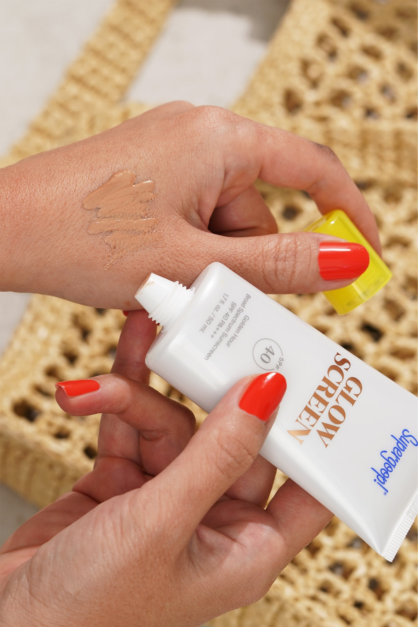 Supergoop! Glowscreen in Golden Hour, Hermes Orange Poppy on the nails 