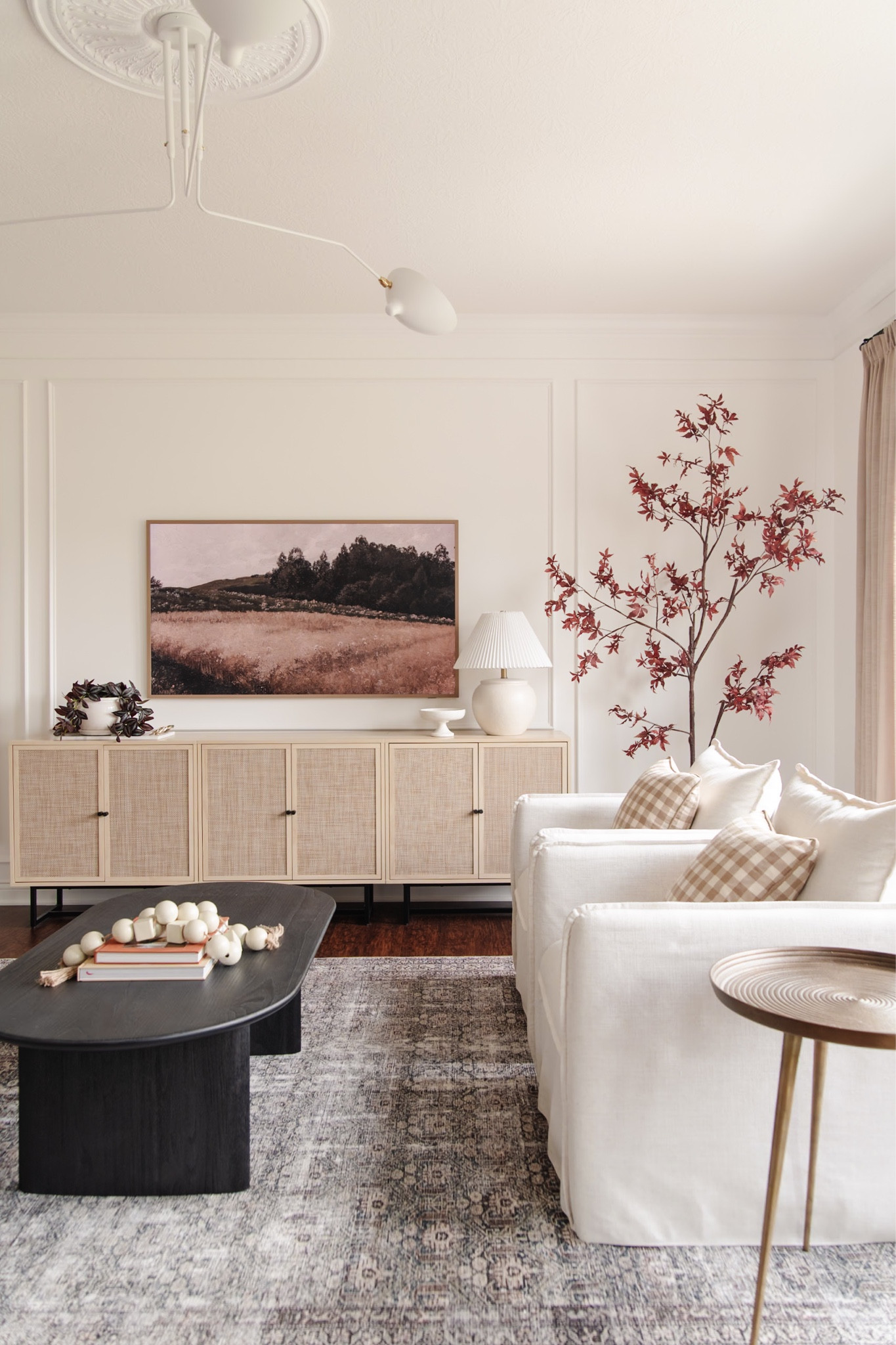 Cozy fall living room decor, amber lewis loloi rug, faux fall tree, artificial autumn tree, black coffee table, budget cane cabinets as media console tv stand

#LTKhome #LTKsalealert #LTKSeasonal