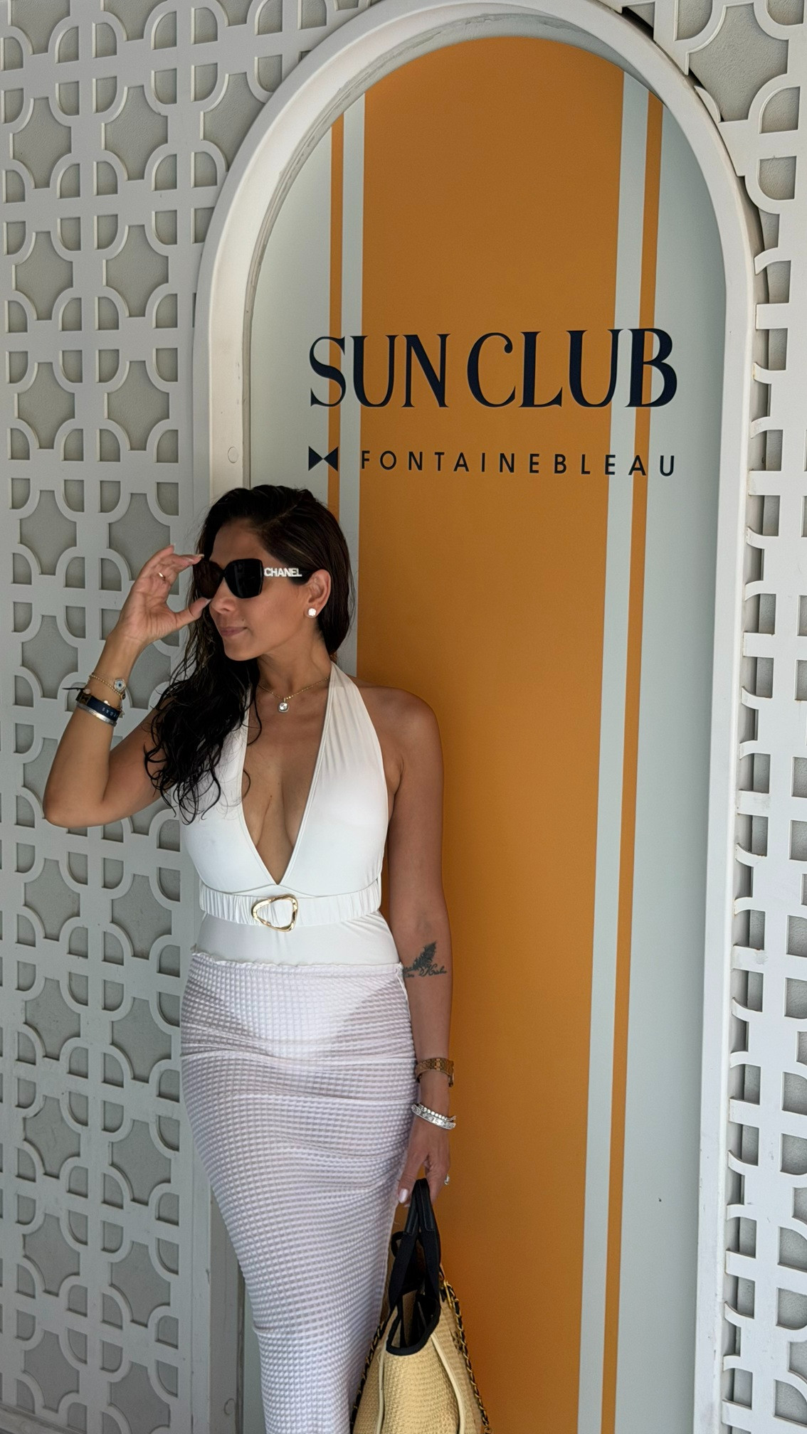 Chasing the sun in my absolute favorite poolside look. ☀️ This white belted Lulu swimsuit is incredibly flattering, and pairing it with a sheer maxi skirt takes it instantly from the cabana to the day club. 🤍🍹 

 #LTKvlog #LTKSeasonal #LTKSwim