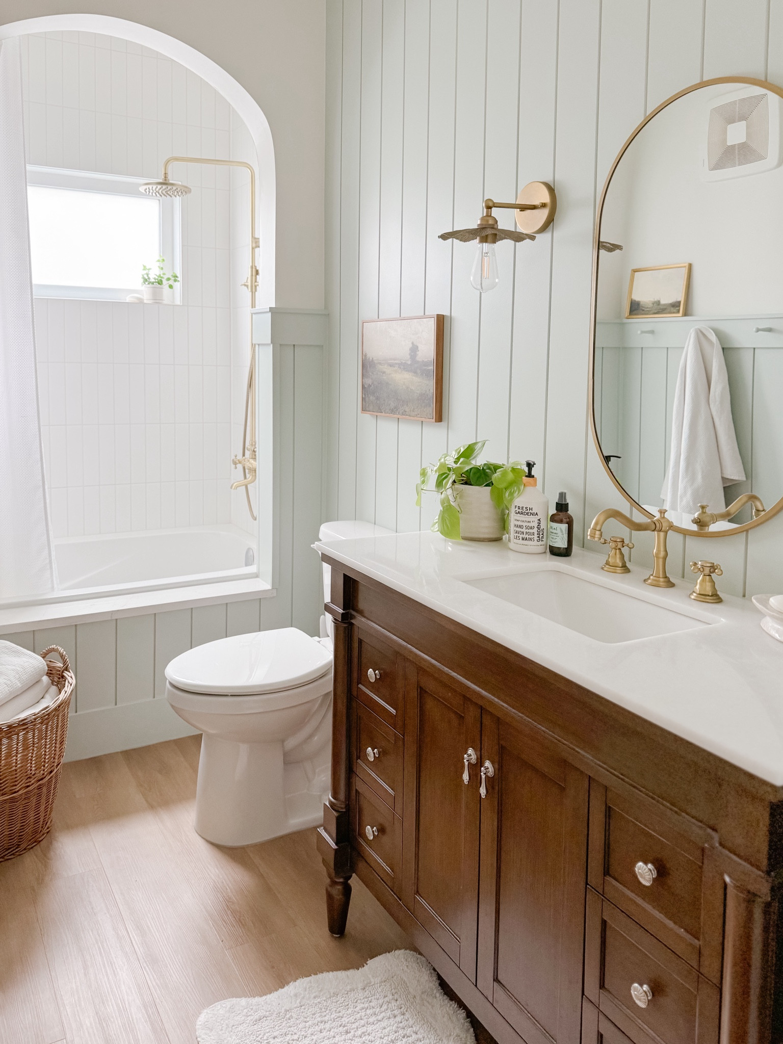 English country cottage bathroom, floral wall sconces, walnut vanity, brass faucet, brass shower faucet 

#LTKHome