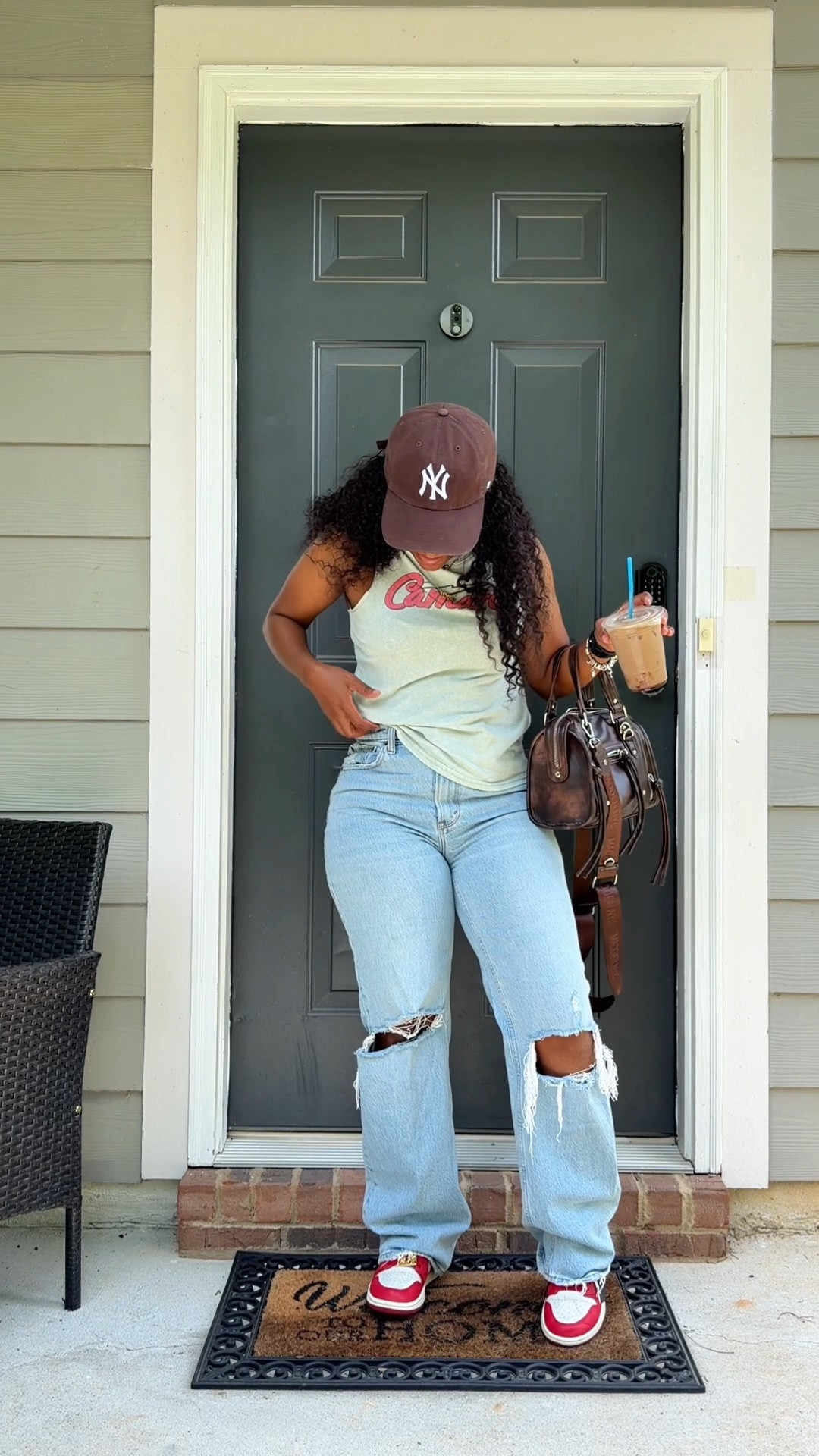 Easy, casual, and perfect for summer. 
I paired this graphic tee with high-waisted distressed jeans, a brown NY hat, a brown faux leather bag, and my Jordan 1 x Teyana Taylor Zoom Comfort sneakers for a comfy everyday look. This is one of those summer outfits over 40 that feels effortless but still put together.

#LTKootd #LTKOver40 #LTKPetite