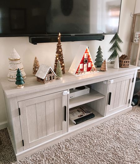 Christmas village setup in my living room 🏠🌲 the Christmas trees are from all over. The wooden houses are my favorite!! They have candles inside of them. I also found this a-frame light up cabin from targets Christmas decor selection and LOVE it!

#LTKSeasonal #LTKHoliday #LTKhome