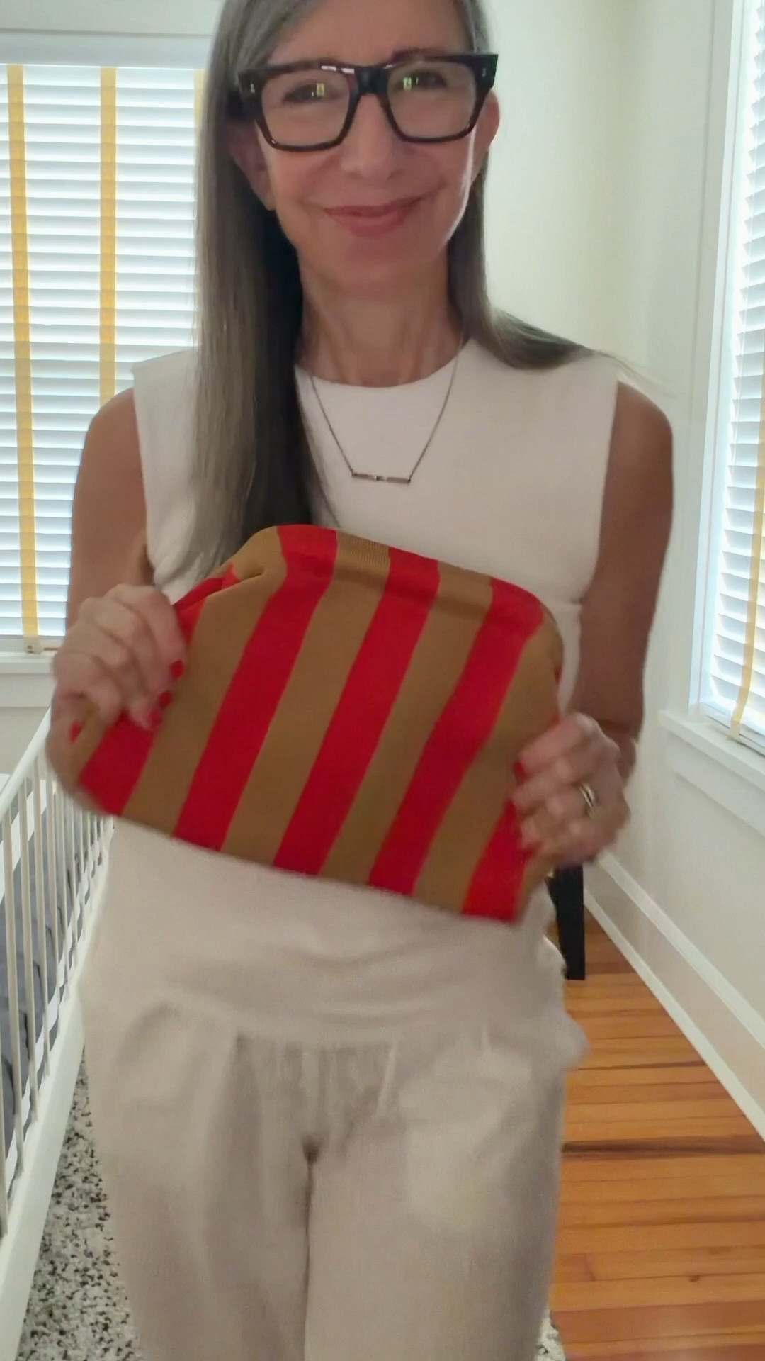 White Zara sleeveless structured tank, white eyelet wide leg pants, clear jelly flats, red and tan striped knit clutch. All white summer outfit with one color pop — the bag does everything. No jewelry, no layers, just one deliberate choice. Pants and jellies linked. Clutch is from a small independent maker, not on LTK.

#LTKgrwm #LTKootd #LTKOver40