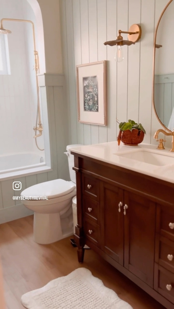 Shop our boho cottage bathroom, flower sconces, pill mirror, brass shower faucet, arched shower, vintage inspired vanity 

#LTKhome #LTKVideo #LTKMostLoved