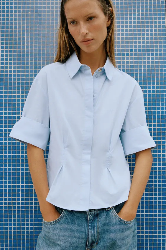 Model height: 177 cmPoplin shirt with a regular collar and short sleeves with turn-up cuffs. Feat... | Zara IT