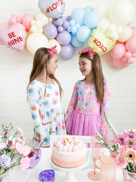 Sweethearts 💜🩷 

#ad found the most perfect conversation hearts dresses to match our Valentine’s party this year. @bumsandrosesofficial bamboo material clothes are silky smooth, stretchy and so comfortable on skin. 


#ltkfamily #ltkkids #sisters #family #mom #matchingfamily #matchingpajamas#bamboopajamas #kidsclothes #kidsfashion #valentinesdecor #valentinesgift #valentinesparty #valentinesday #lovebasket #ltkparties