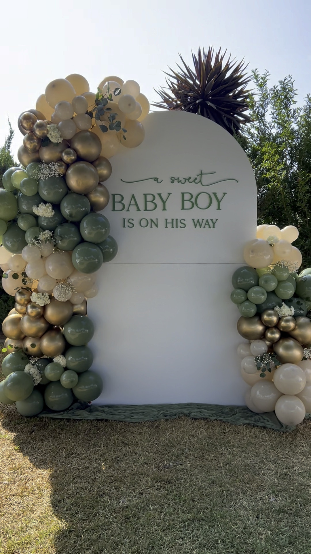 A sweet baby boy is on his way green, beige and gold, baby shower balloon backdrop 