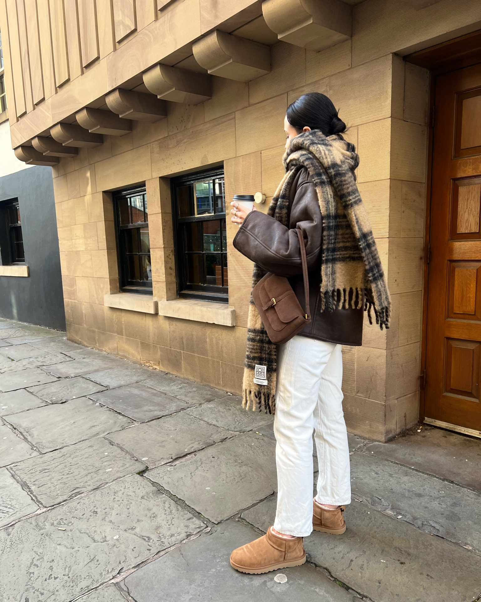 shearling coat from mango in brown (also comes in black) 
toteme scarf 
toteme scarf dupe from arket 
toteme white jeans 
white jeans from arket 
ultra mini uggs in chestnut 
brown suede miranda bag from by far (in the sale) 
off duty casual style 
weekend style 
comfy style 

#LTKstyletip #LTKSeasonal #LTKeurope