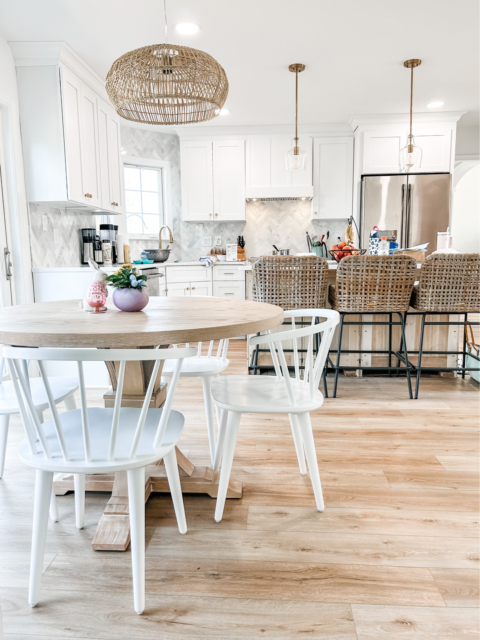Working on a client’s kitchen today and loving how the new kitchen table, dining chairs, bamboo light fixture and rattan kitchen counter stools are coming together.

Woven bar and counter stool, counter height woven bar stools with back, kitchen island bar stools, woven counter stools, rattan counter stool, Windsor dining chair, spindle dining chair, white dining chair, curved spindle dining chair, white washed round pedestal dining table, round dining table, round farmhouse table, bamboo open weave orb pendant light fixture, bamboo chandelier, kitchen light fixture, kitchen chandelier, brass glass kitchen pendant light. 
#kitchen 

#LTKhome #LTKFind #LTKstyletip