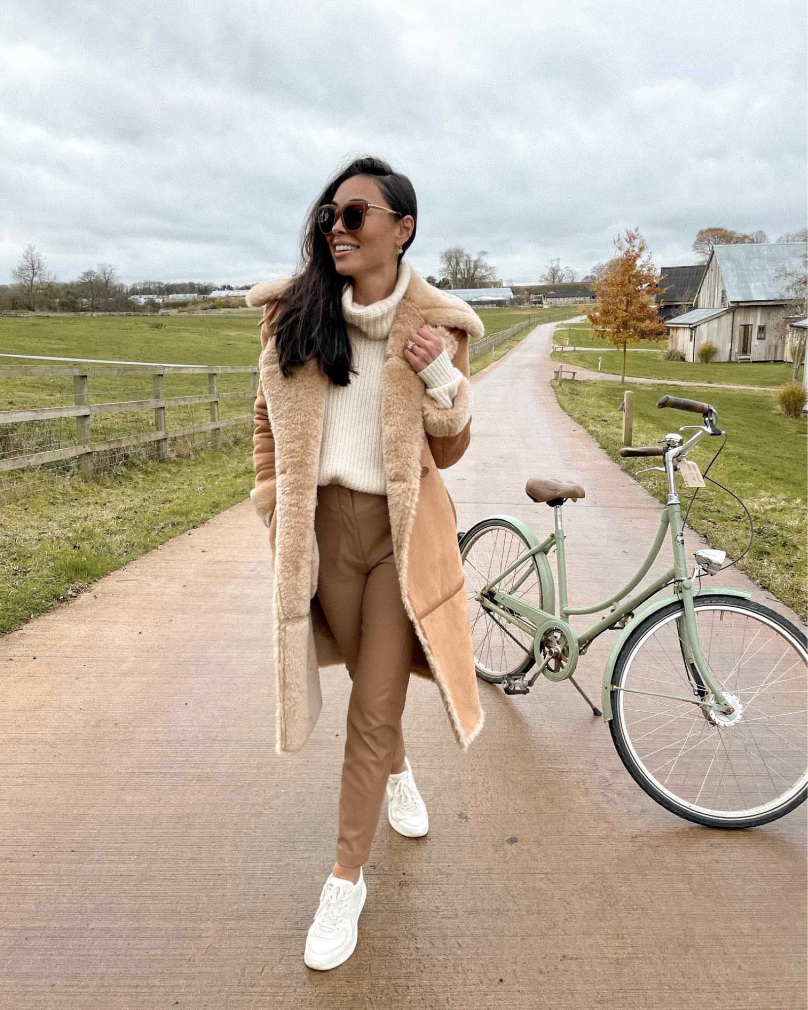 Kat Jamieson of With Love From Kat wears a fall outfit. Neutral coat, cream sweater, white sneakers, tan sunglasses, fall style, neutral outfit. 

#LTKSeasonal #LTKstyletip