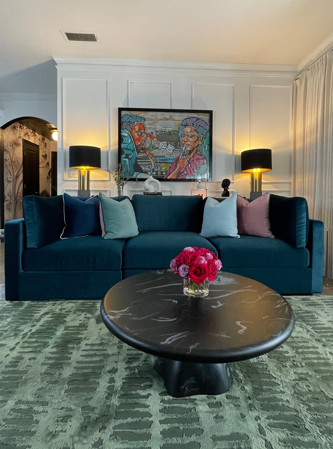 Colorful living room with faux marble coffee table from CB2 and lamps and console tables from Ashley Furniture.

#LTKHome