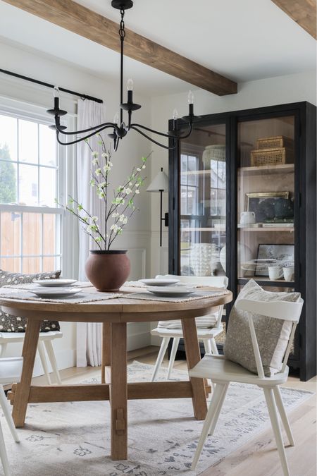 Dining room furniture, dining room table, white dining chairs, display cabinet, black cabinet, metal chandelier, vase, terracotta vase, spring stems, throw pillow covers  

#LTKhome #LTKSpringSale #LTKfindsunder100