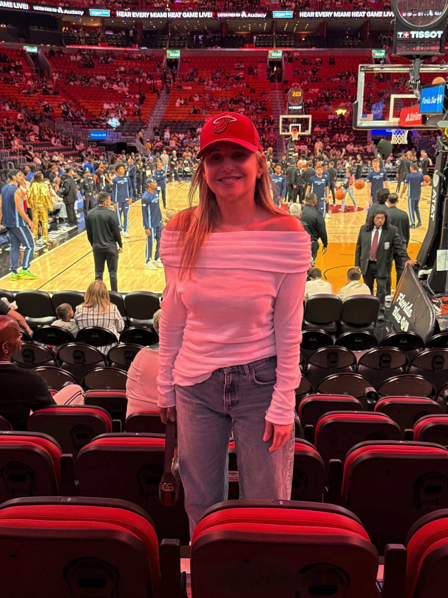 At a Miami Heat game wearing a white off the shoulder  top from Zara, light wash jeans, a red Miami Heat hat ❤️ + a small Gucci shoulder bag

#LTKSeasonal #LTKSaleAlert #LTKootd