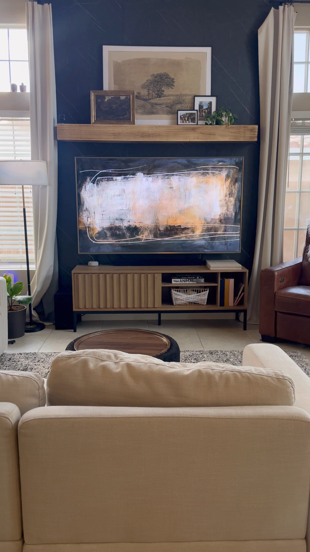 Finally got a chance to update our tv wall. I originally had some shelves from IKEA hanging above the wall, but it just didn’t make a statement like I wanted it too. I picked up this mantle from @wayfair and it was stained in this red oak color, so I sanded it down so it would be closer to the color of the tv console I already had. 

Wade had to leave after we took the older shelves down and I was able to hang the mantle all by myself 💪🏾 

I located all five studs in the wall and mounted the wall piece the mantle attached to first. This mantle is super secured to the wall so I don’t have to worry about it falling and hurting anyone or damaging our tv. 

I hung an art piece from @target and printed out a large print I purchased off @etsy . Of course I added in some cute metal framed photos I took for our kids birthday this year from @artifactuprising 

I think it looks so much better and I can’t wait to change it up for the holidays! ✨ What do you think? Does a mantle work over a TV?



#tvwall #interiordesign #homedecor #mantle #rentalupgrades #easydiy #walldecor 

#LTKStyleTip #LTKHome #LTKVideo