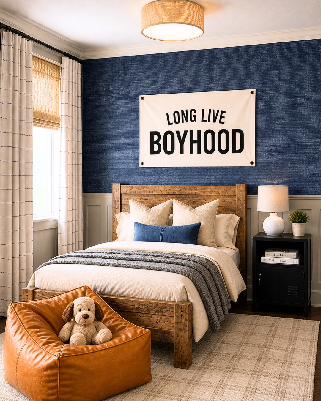 Boy room design… but make it elevated 🤎🏀🏈 Linking this entire Amazon bedroom because the navy grasscloth-inspired walls, warm wood furniture, layered neutrals, sporty wall decor, woven shades, and cozy cognac bean bag came together SO good 👏🏻 The perfect mix of playful + timeless that can grow with them for years.

Amazon favorites in this space:
• wood bed + dresser
• woven flush mount light
• neutral plaid rug
• navy accent wall inspiration
• sports wall decor + mini hoop
• blackout curtains + woven shades
• cozy layered bedding
• cognac lounge chair/bean bag

I love how this room feels boyish without being overly themed 🤍 Everything is linked on my LTK! #LTKHome #AmazonHome #BoysRoom #KidsRoomDecor #AmazonFinds #ModernClassic #InteriorDesign #BoysBedroom #NeutralHome #SportsRoom #CozyHome #HomeDecor #BedroomInspo #TraditionalHome #PorcheandCo

#LTKSaleAlert #LTKHome #LTKKids