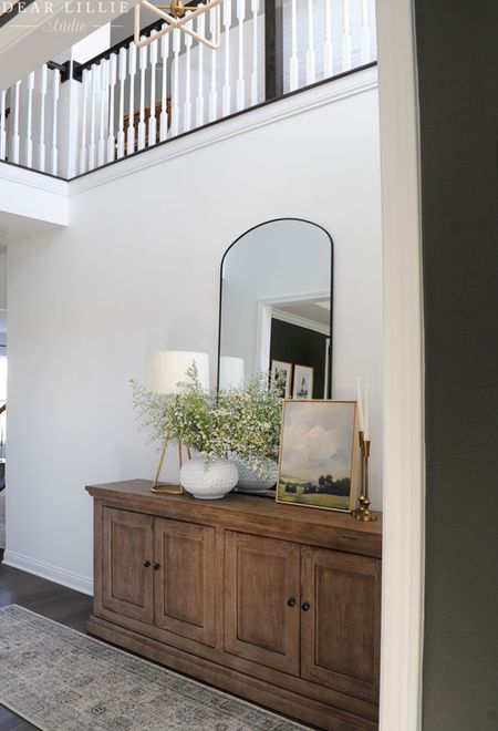Neutral entryway with wood console and large arched mirror...

#LTKHoliday #LTKSeasonal #LTKhome