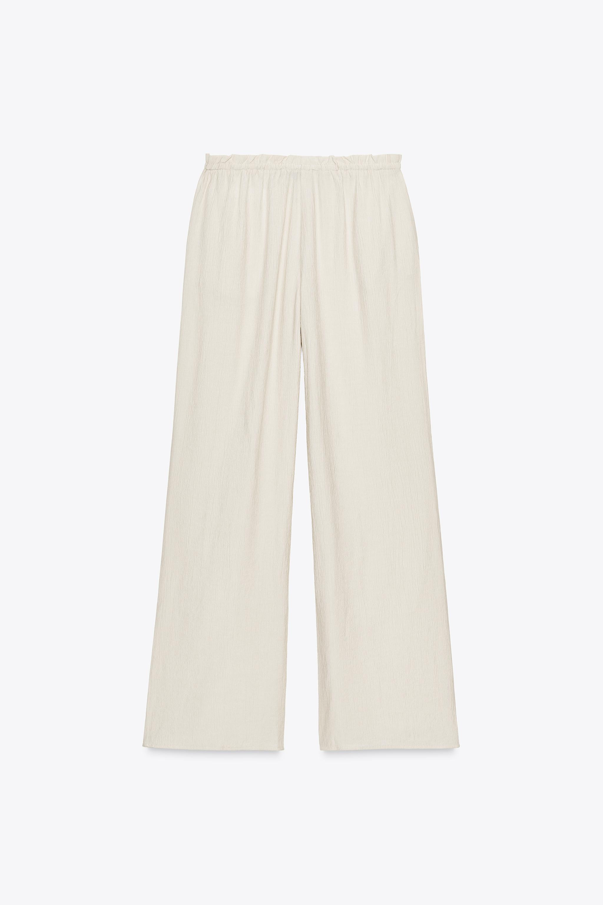 Loose-fitting mid-waist trousers with an elastic drawstring waistband. Featuring side pockets. Te... | Zara UK