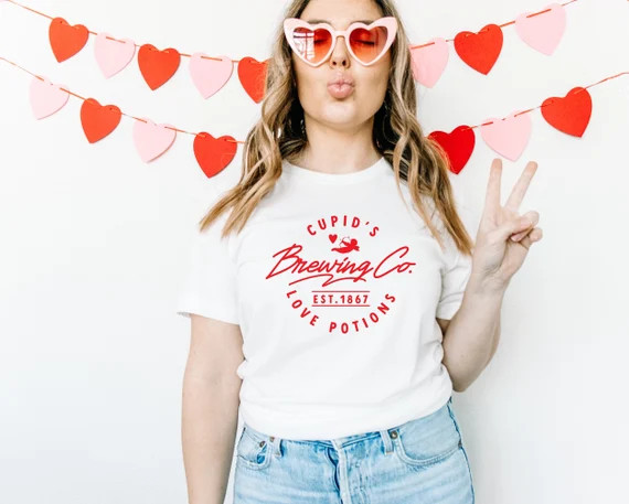 Cupids Brewing Co Unisex Jersey Short Sleeve Tee | Valentines Day Graphic Tee for Women, Gift for... | Etsy (US)